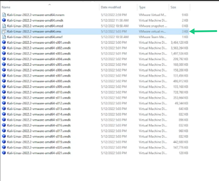 Locating and selecting the .vmx VMware virtual machine configuration file inside extracted folder.